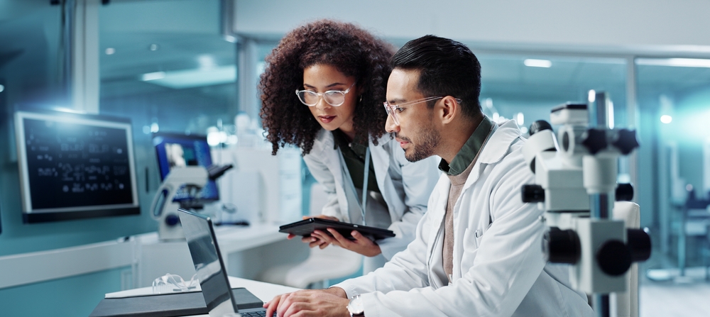 Science,,Teamwork,And,Scientist,With,Tablet,In,Laboratory,For,Communication,